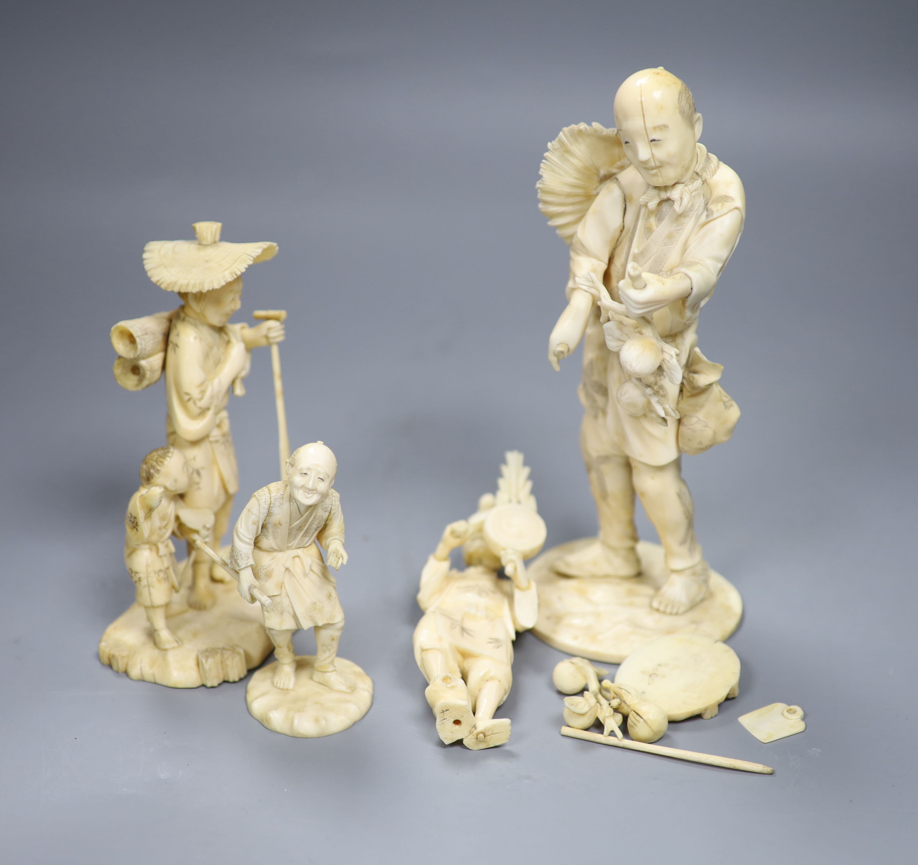 Four 19th century Japanese carved ivory figures, tallest 21cm